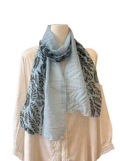 Light blue sheer scarf with contrasting dark leaf-print panels