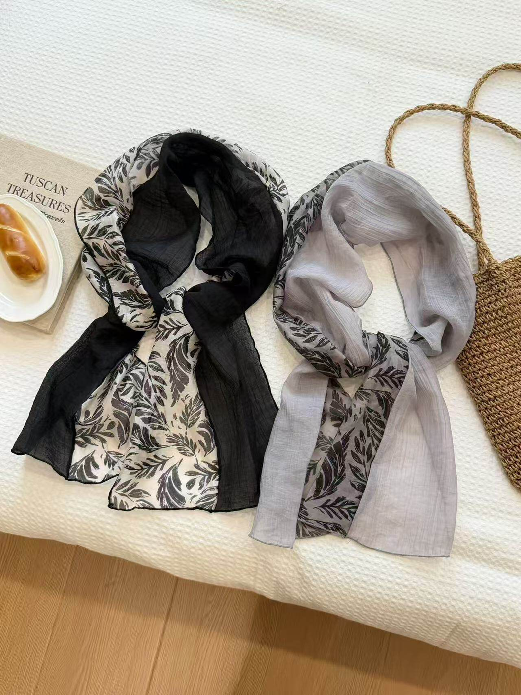 Black and mist gray leaf-print scarves displayed together
