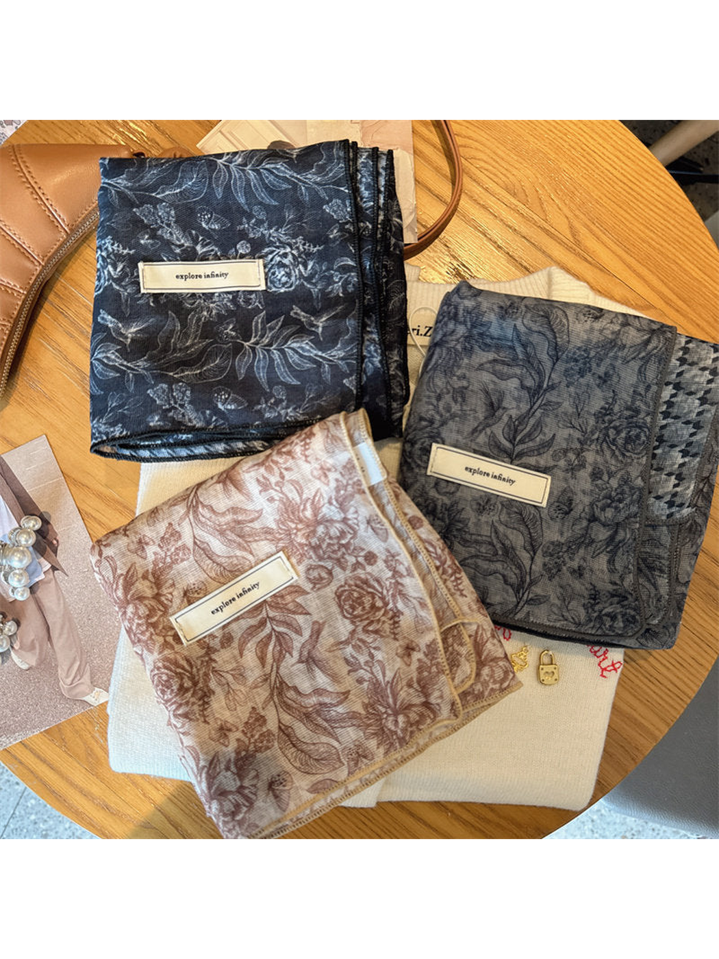 Navy, blush and gray-blue floral scarves displayed together