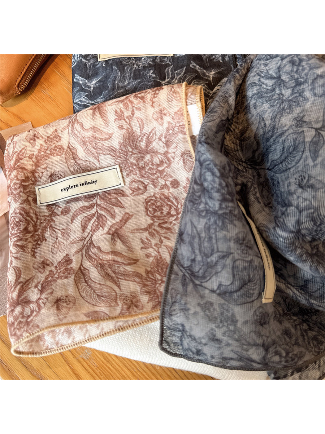 Close-up of floral scarf patterns and narrow stitched edges