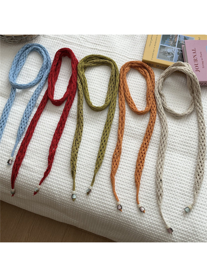 Light blue, red, olive, orange and beige openwork scarves displayed together
