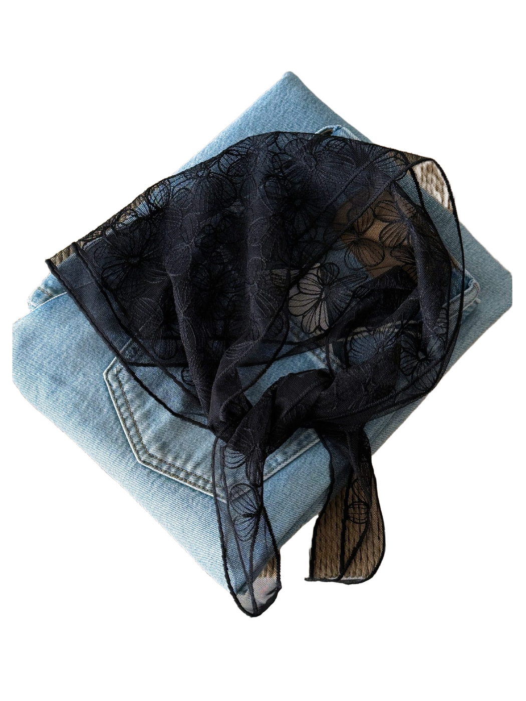 Black sheer floral scarf arranged over denim to show the embroidered flower pattern