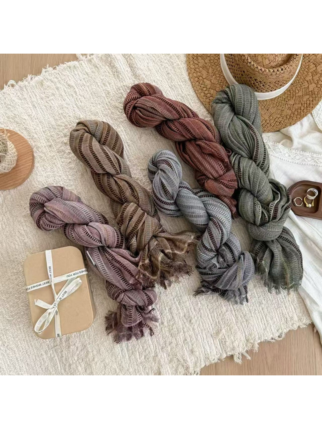 Five striped scarves in muted colors arranged in braided folds