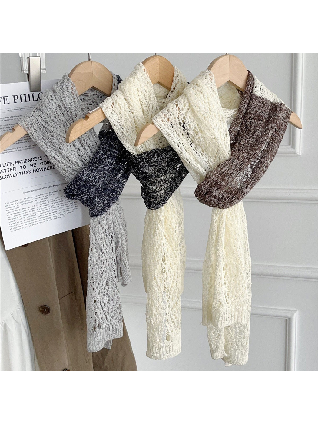 Three two-tone openwork scarves displayed on wooden hangers
