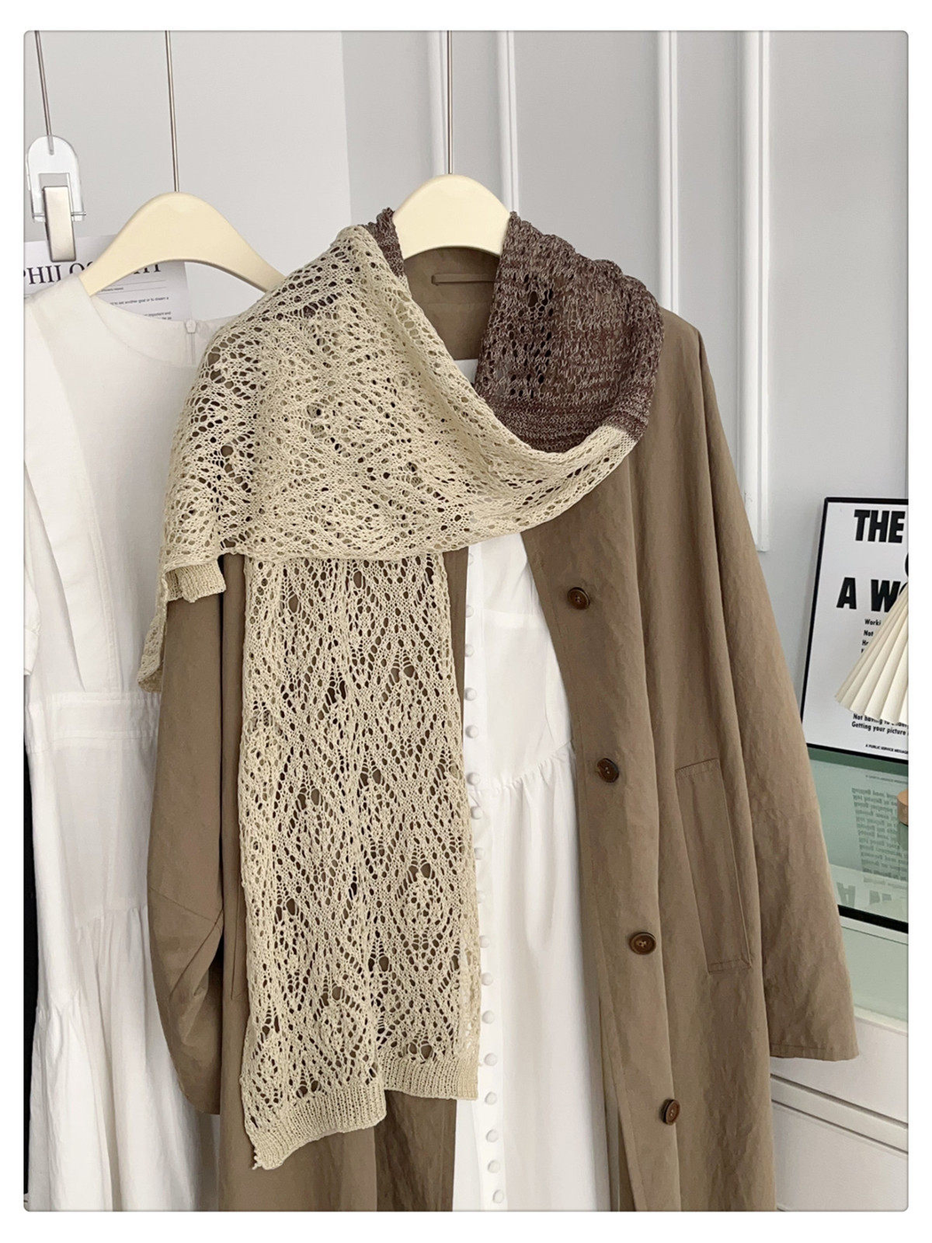 Beige and brown openwork scarf draped in a long front view