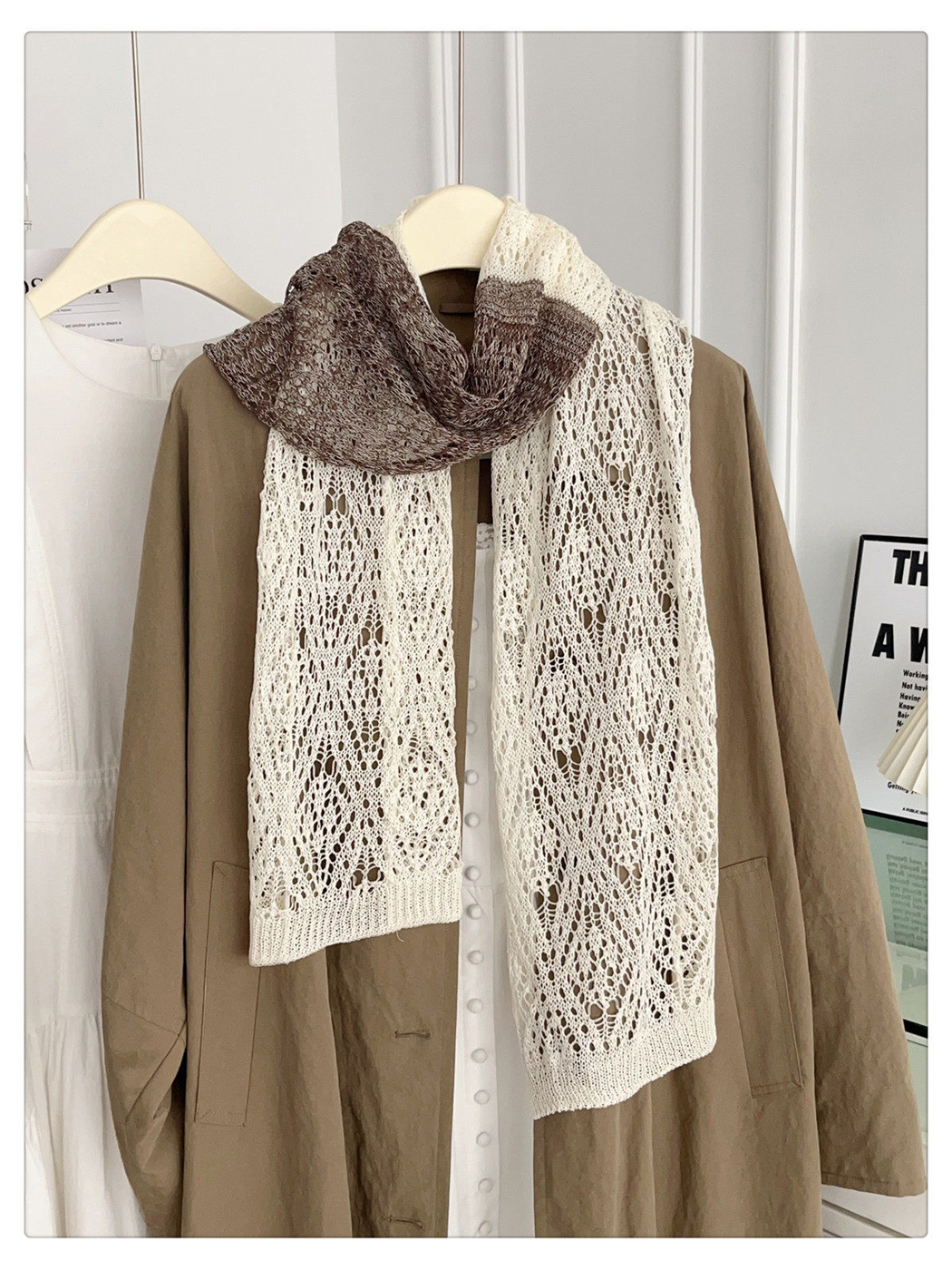 Ivory and brown openwork scarf hanging in a full front view