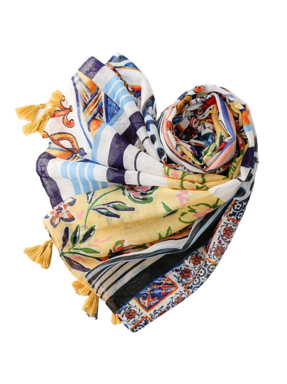 Multicolor patchwork scarf rolled and loosely draped on a white background
