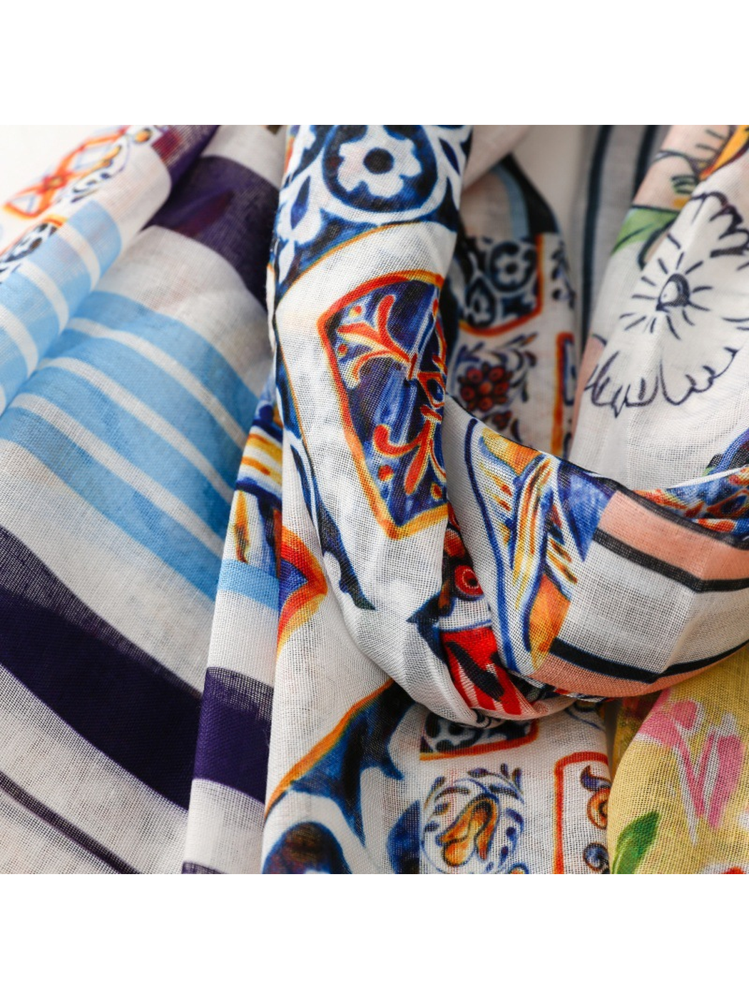 Close-up of blue stripes and ornamental motifs on the draped scarf