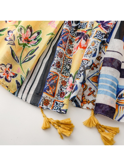 Close-up of the patterned scarf edges with stitched hems and mustard tassels