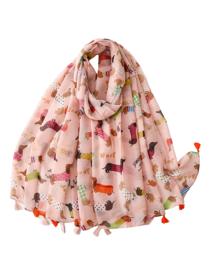 Light pink dachshund-print scarf with alternating orange and pale pink tassels, draped view