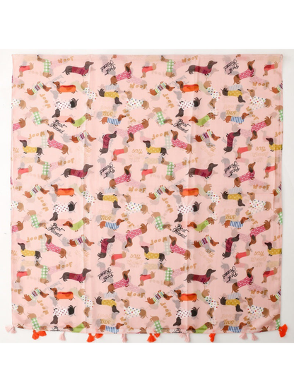 Light pink dachshund-print scarf laid flat with alternating orange and pale pink tassels
