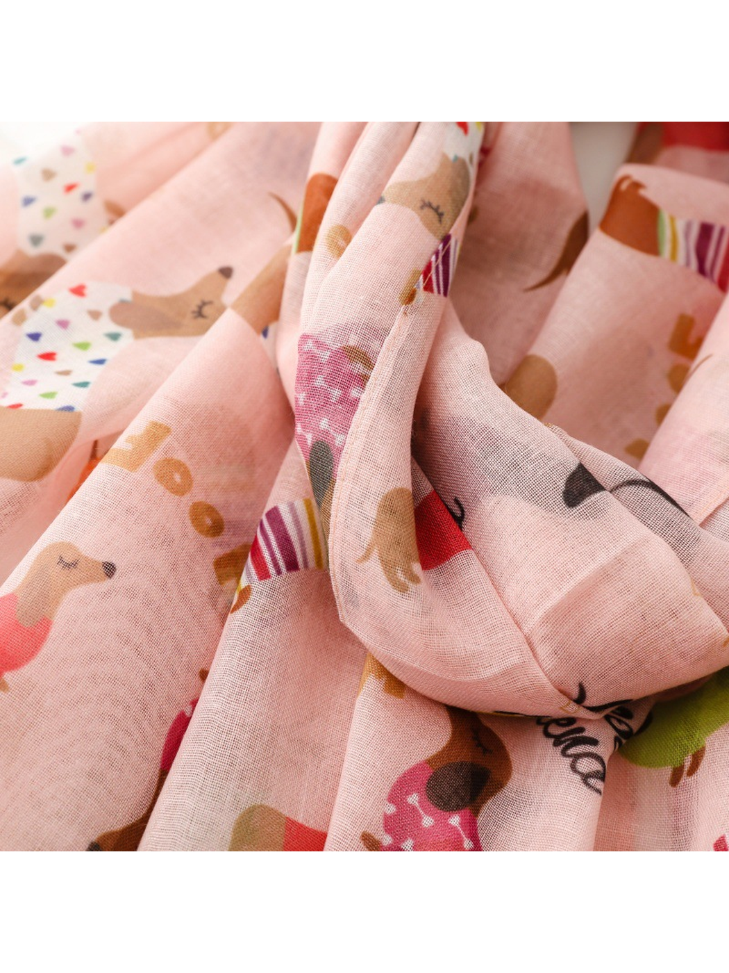 Close-up of the lightweight scarf gathered into soft folds