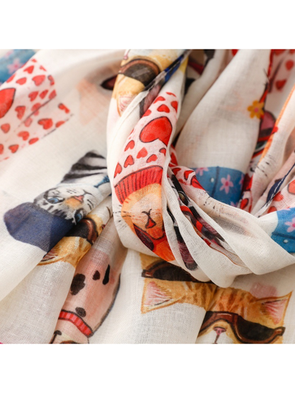 Close-up of colorful cat motifs across gathered scarf folds