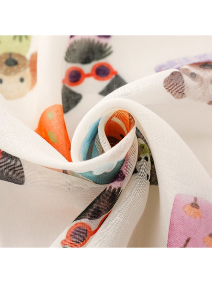 Close-up of the scarf's fine woven-look texture and colorful dog print
