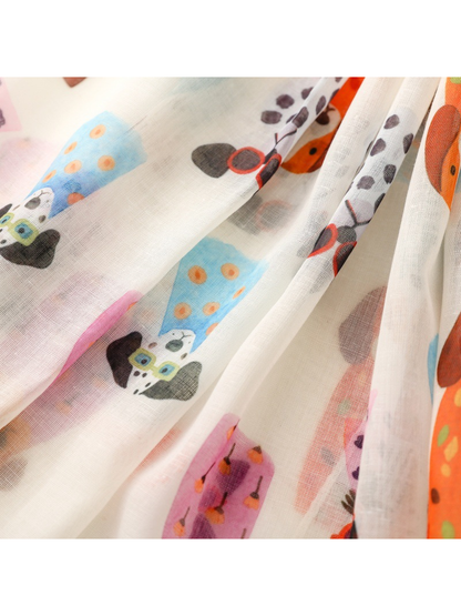 Close-up of sheer overlapping scarf folds with colorful dog motifs