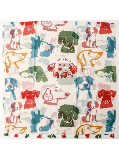 Multicolor dog-print scarf laid flat with tassel trim