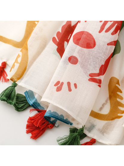Close-up of red and green tassels spaced along the scarf hem