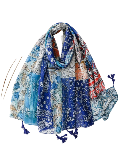 Blue multicolor patchwork-print scarf arranged in a draped display with tassels