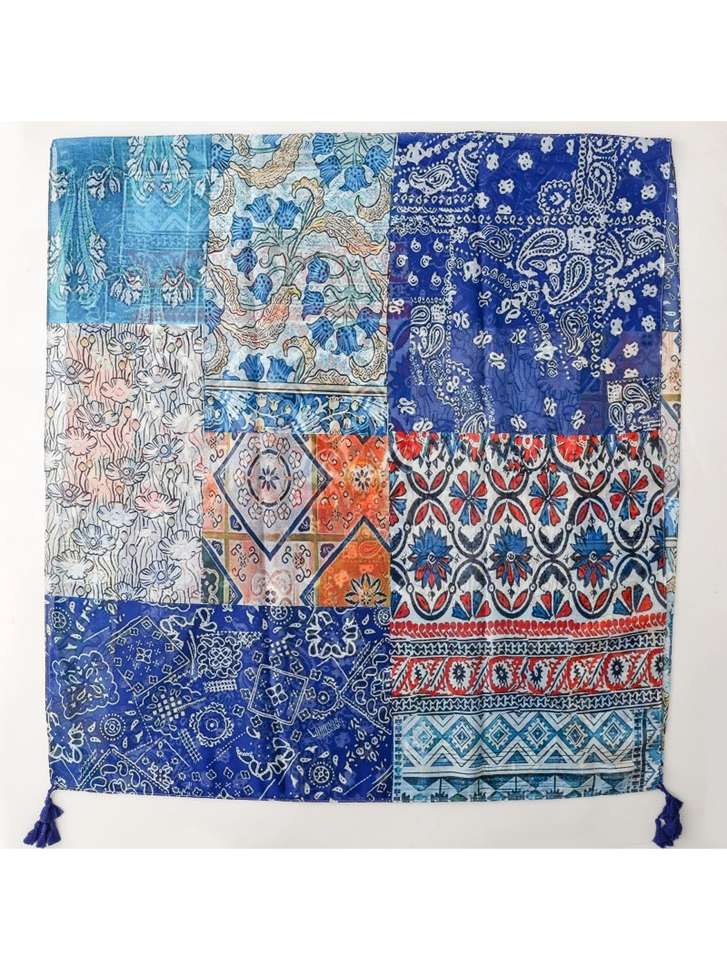 Blue multicolor patchwork-print rectangular scarf laid flat with corner tassels