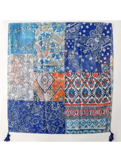 Blue multicolor patchwork-print rectangular scarf laid flat with corner tassels