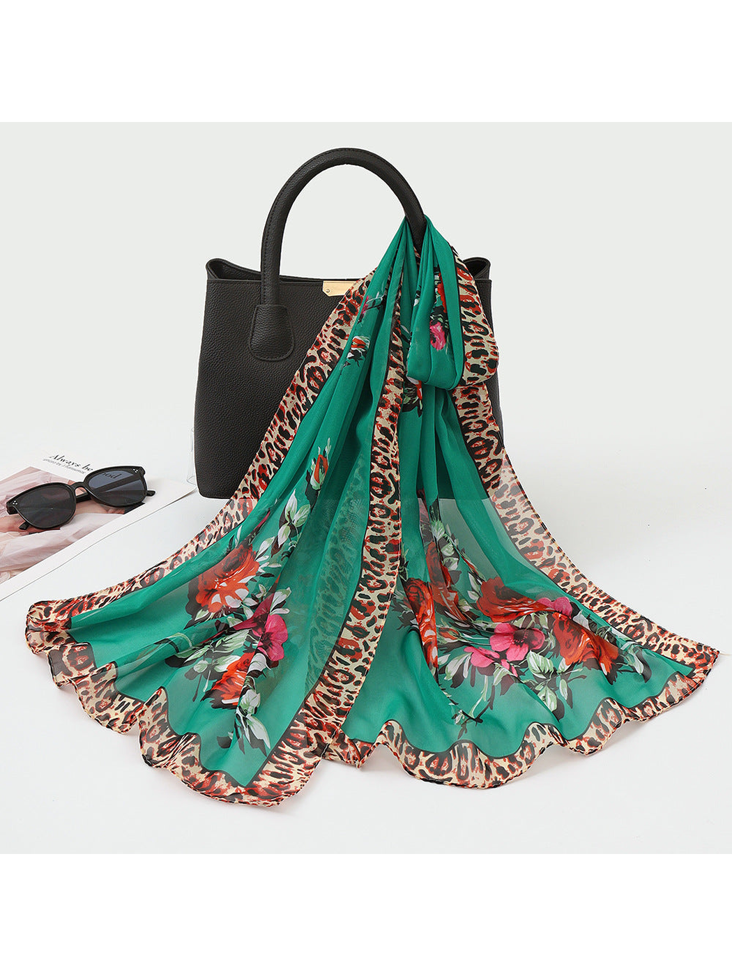 Green sheer floral scarf with leopard-print border, draped view