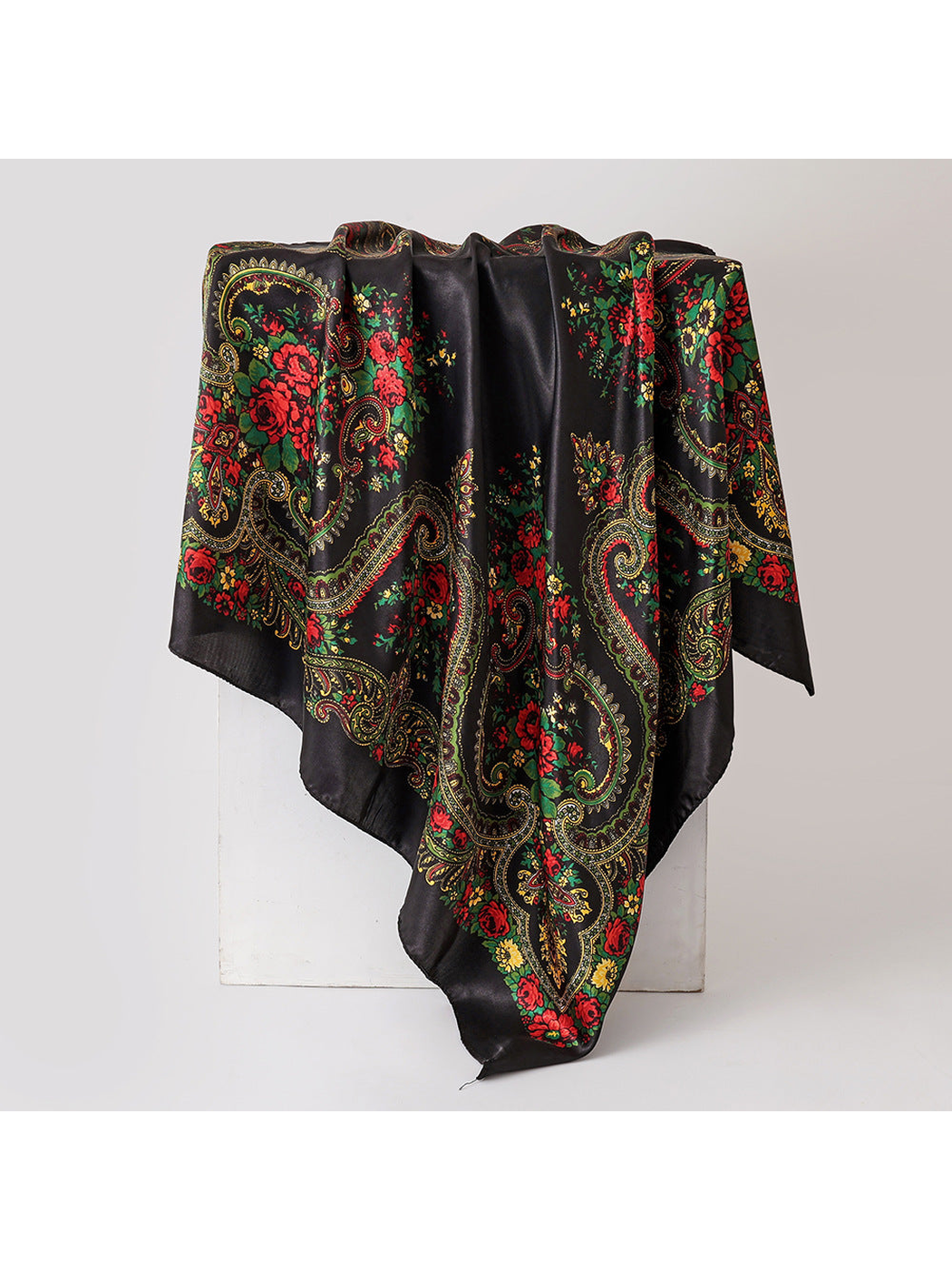 Black square scarf with red floral and paisley pattern, draped view