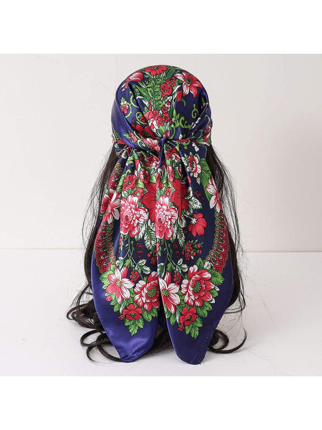 Navy floral square scarf tied on a wig display