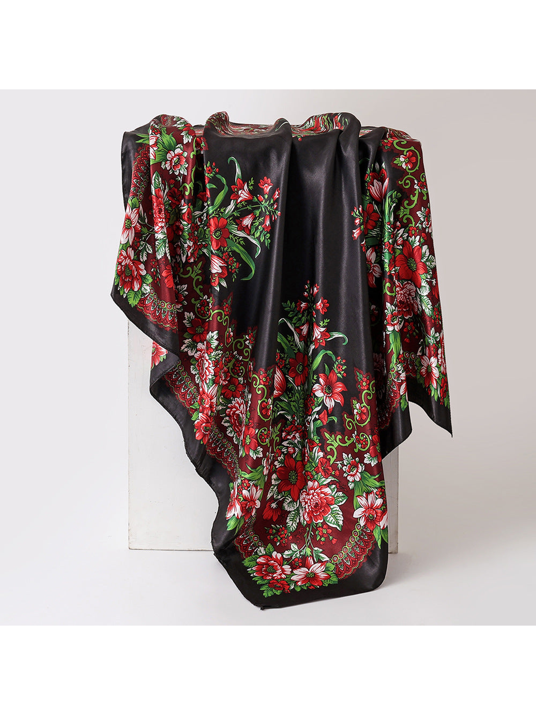 Black floral square scarf in a draped display