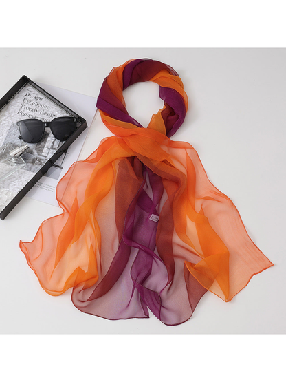 Orange, burgundy and purple gradient scarf arranged in a draped loop