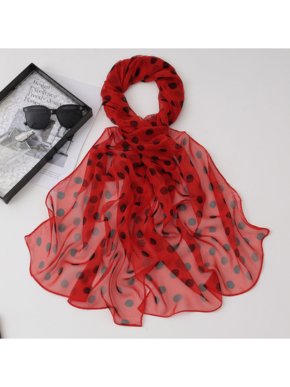 Red sheer polka-dot scarf arranged in a draped loop