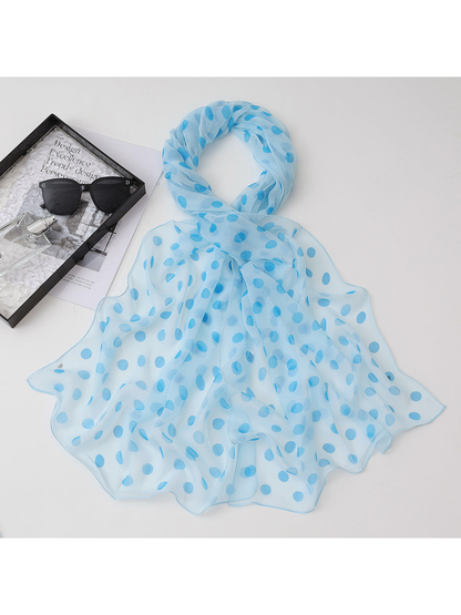 Light blue sheer scarf with blue polka dots, draped view