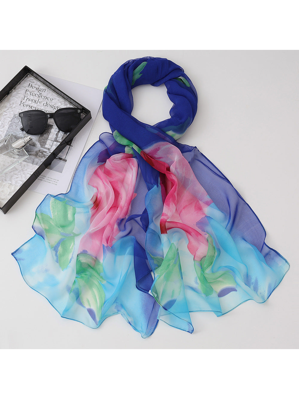 Blue floral scarf with pink blossoms and green leaves