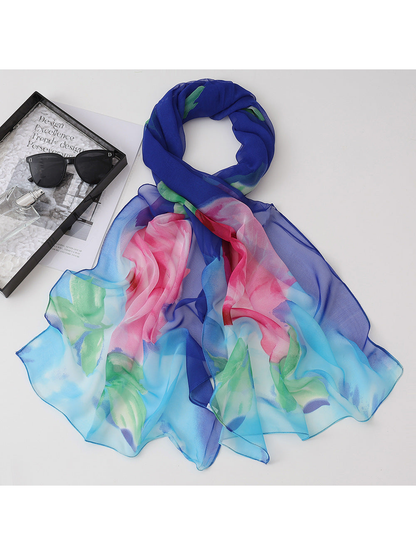 Blue floral scarf with pink blossoms and green leaves