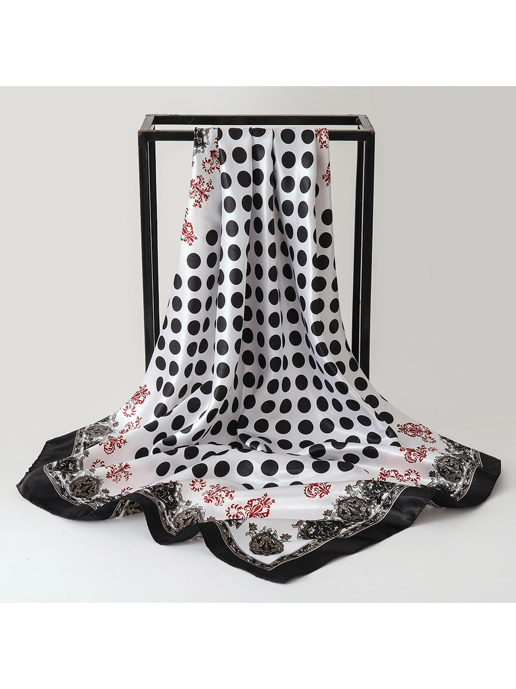 Black and white polka dot square scarf with ornamental border, draped view