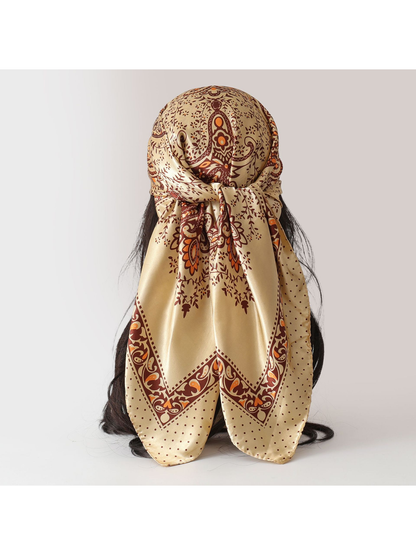 Beige paisley square scarf tied on a display form