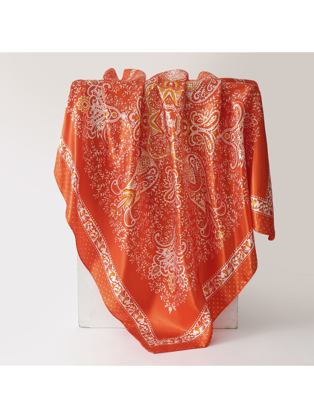 Orange-red square scarf with white paisley print and ornamental border
