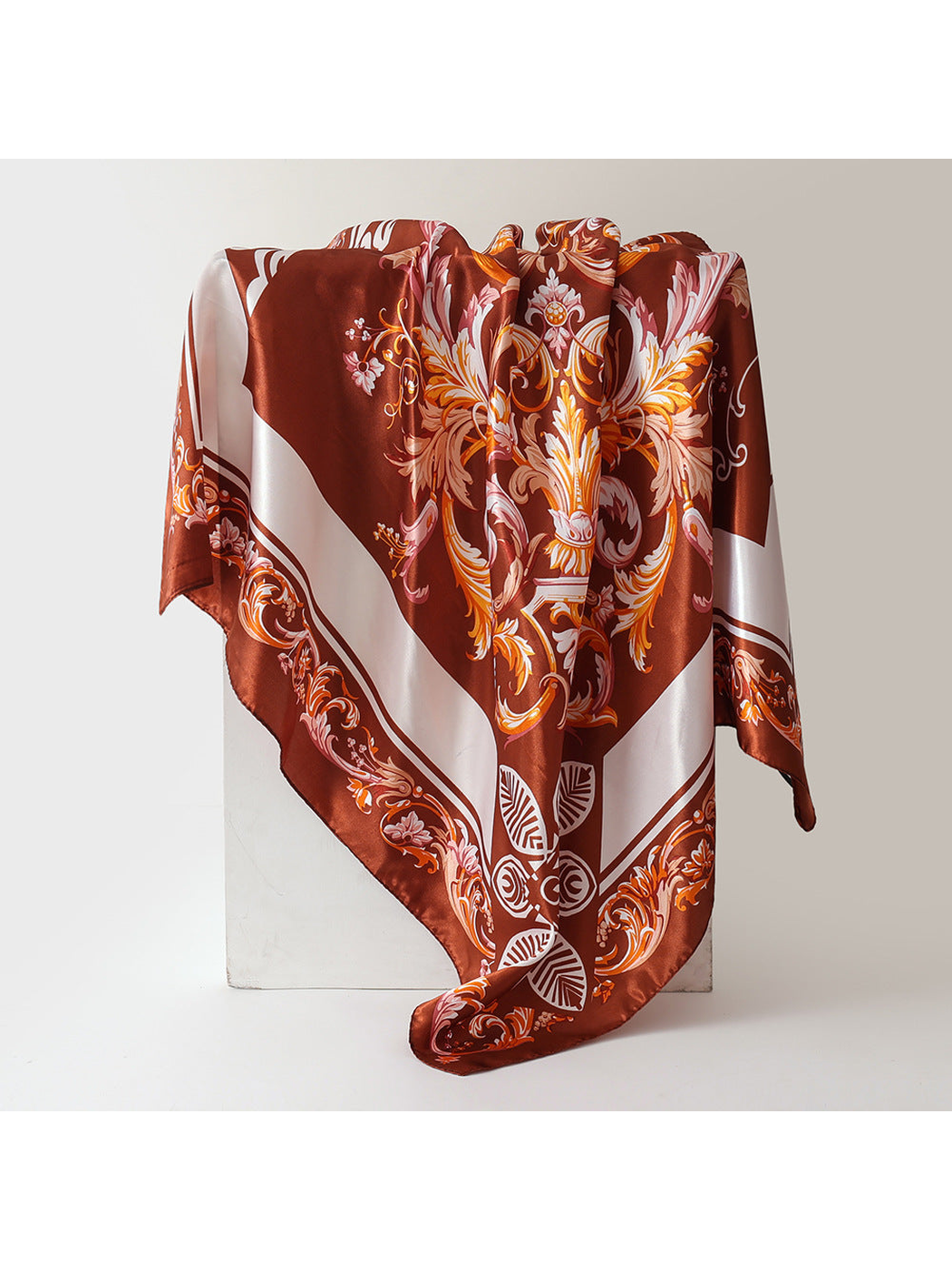 Reddish-brown square scarf with ornate floral scrollwork and cream border