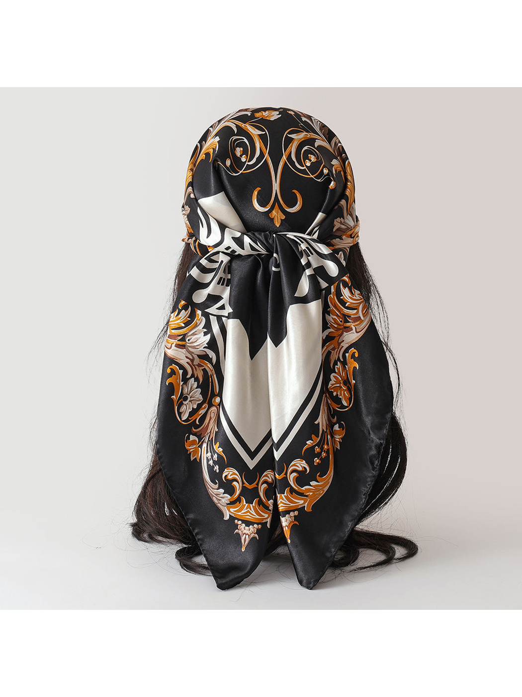 Black ornamental square scarf tied at the back with two pointed ends