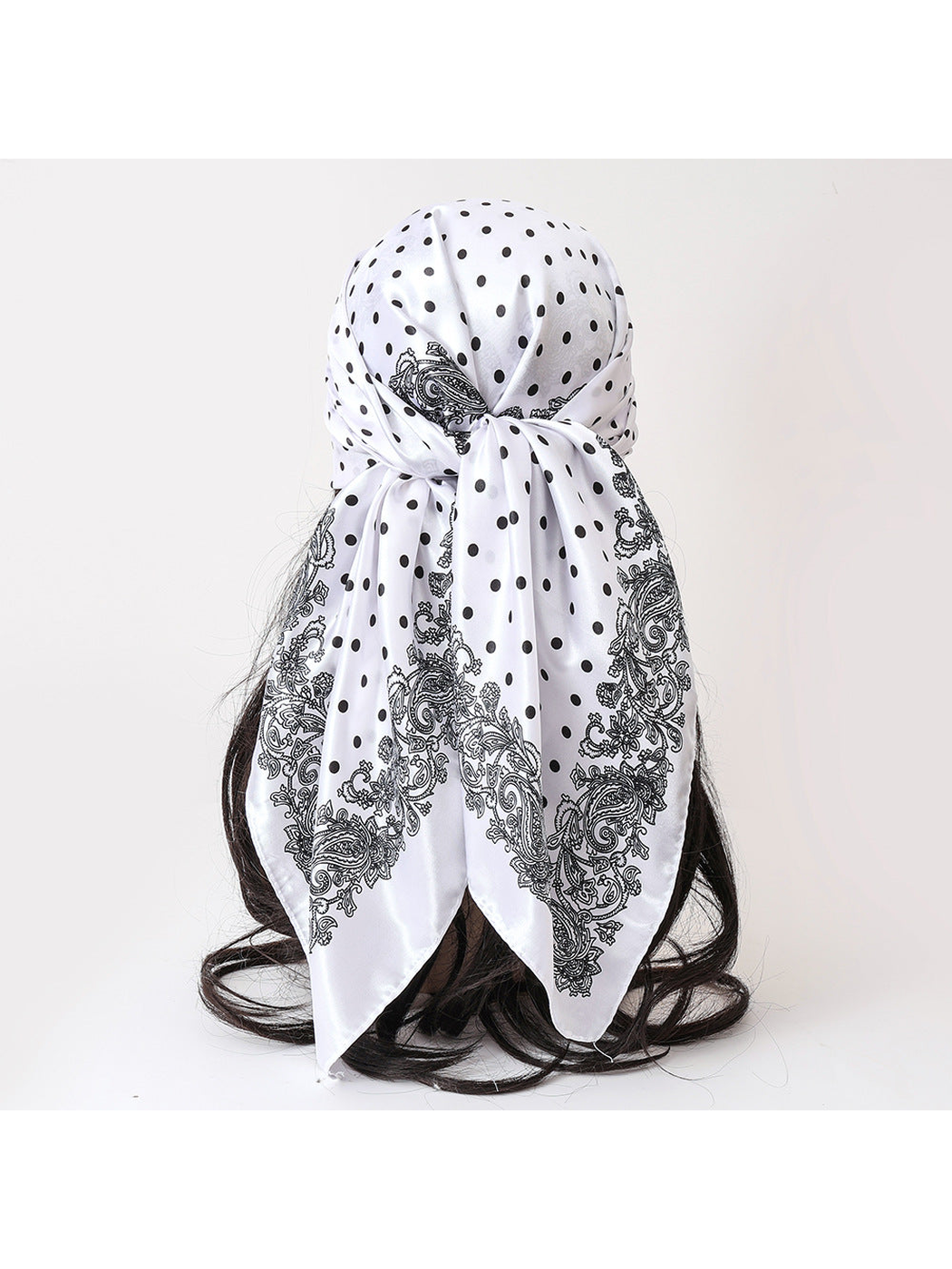 White polka-dot and paisley scarf tied at the back
