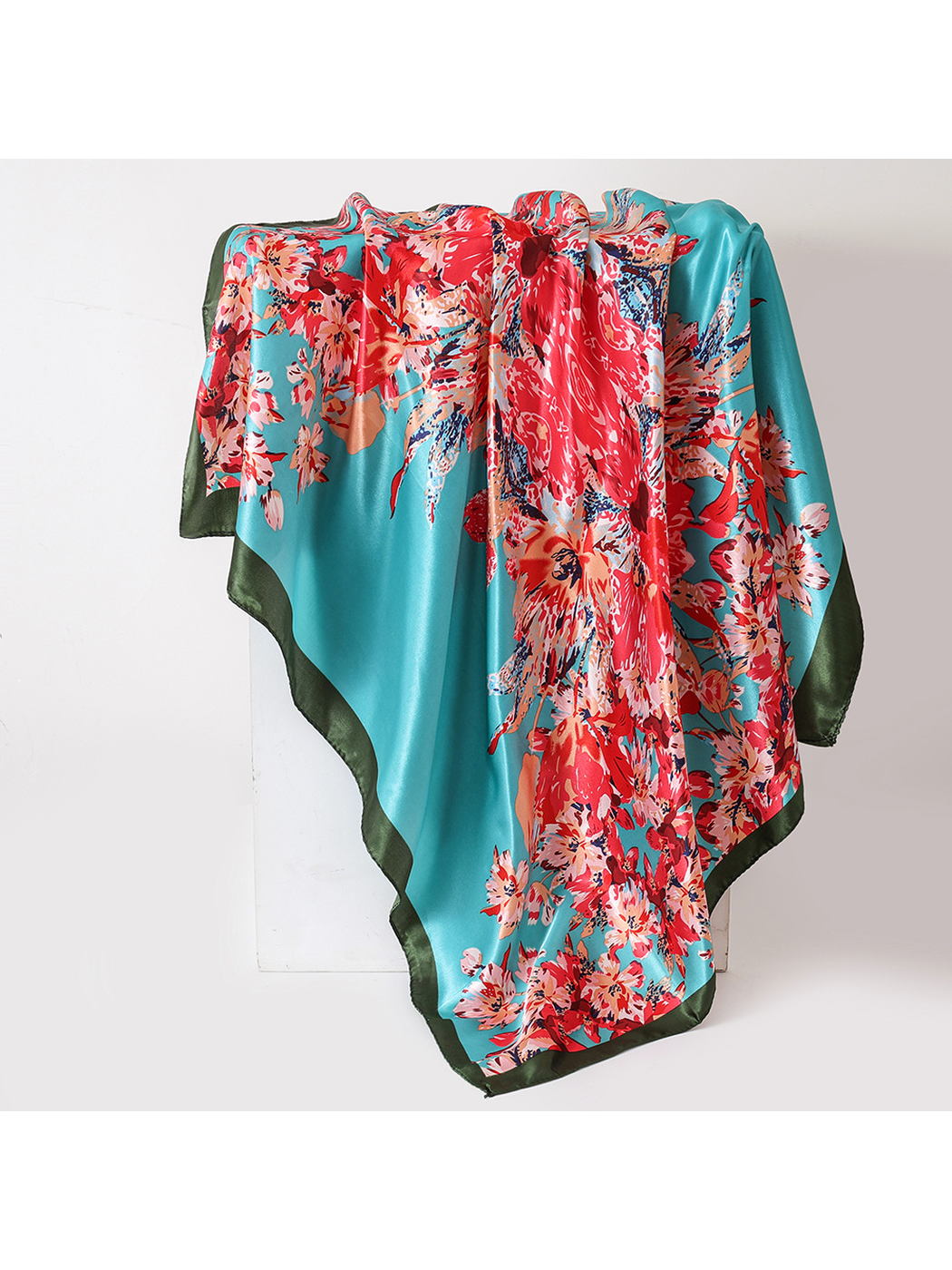 Turquoise floral square scarf with a dark green border, draped view