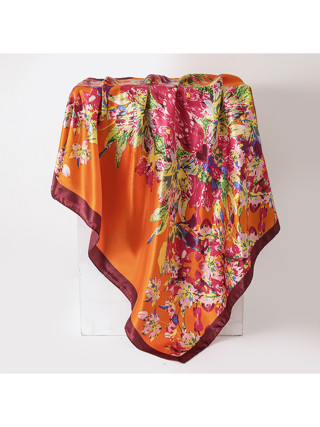 Orange floral square scarf with a deep burgundy border, draped view
