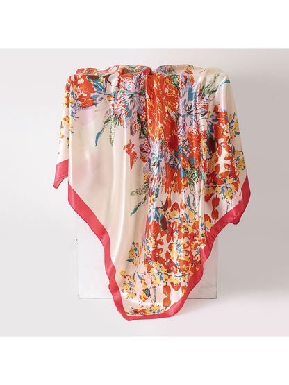 Cream floral square scarf with a coral border, draped view