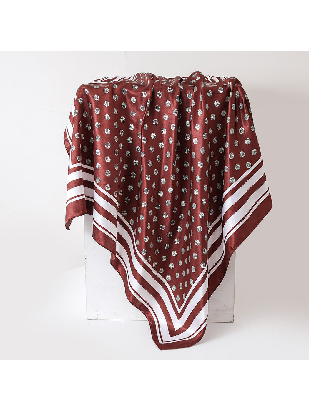 Burgundy square scarf with pale polka dots and striped border, draped view