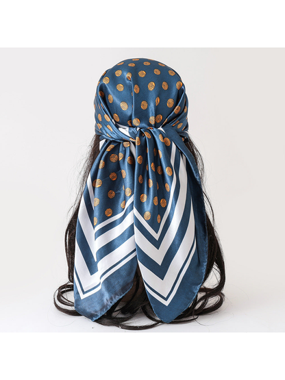 Teal blue scarf with gold polka dots and white striped border, tied back view