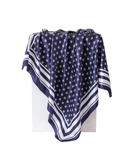 Navy square scarf with white polka dots and striped border, draped view