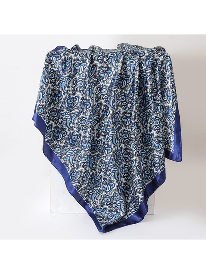 Navy blue paisley square scarf with a solid border, draped view