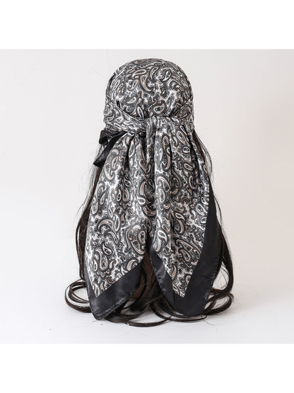 Black and white paisley square scarf tied on a display form, back view