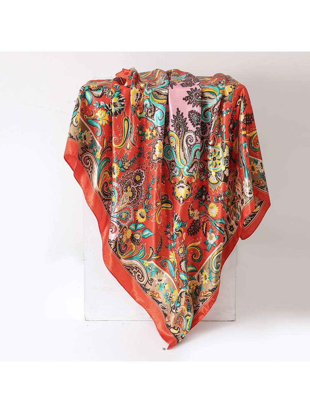 Orange-red floral paisley square scarf in a full draped view
