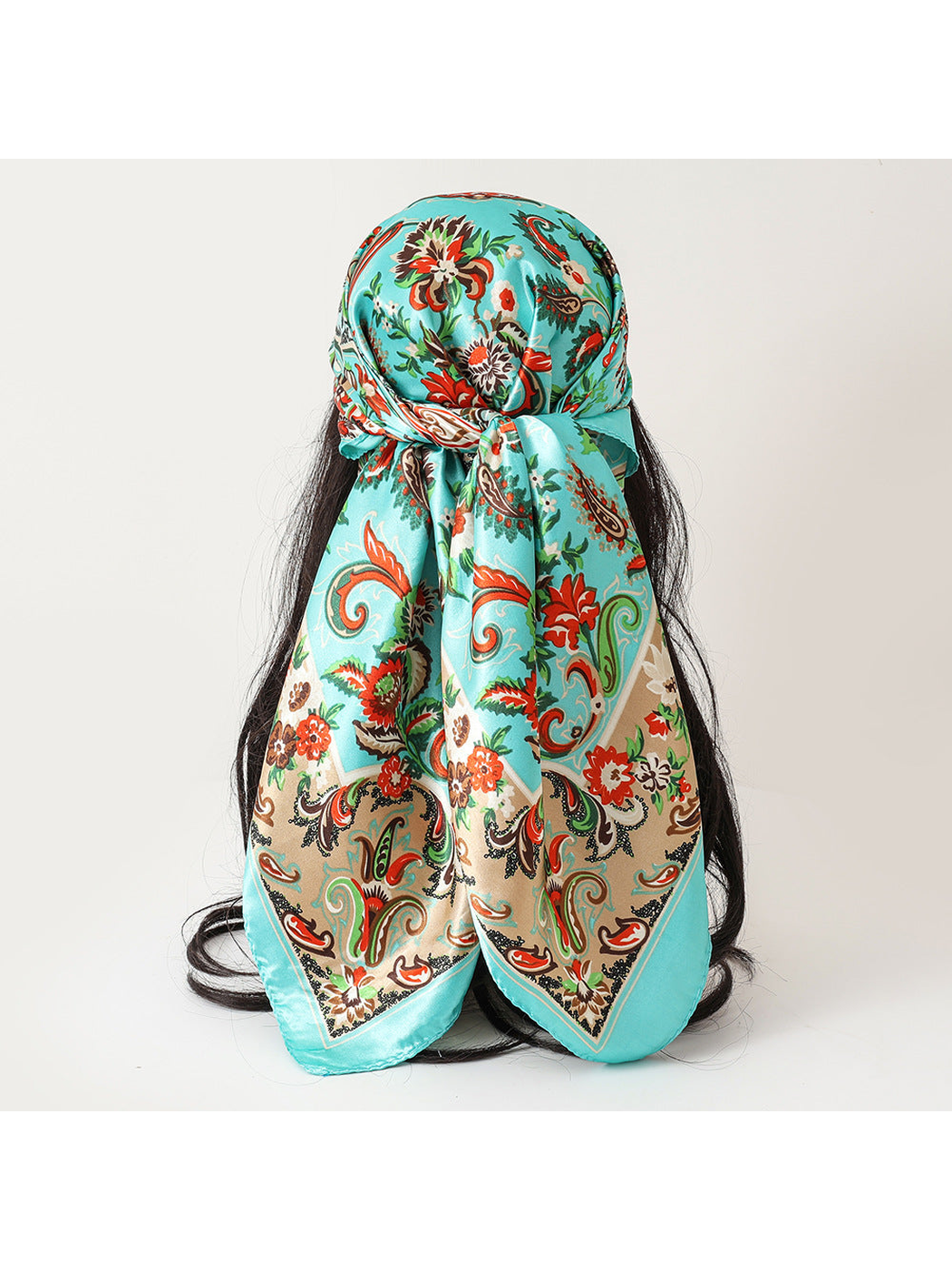 Turquoise floral paisley scarf tied over the hair, back view