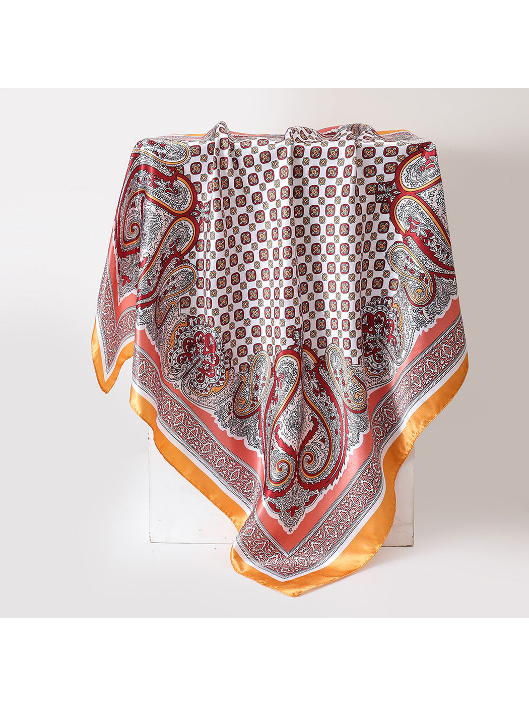 Yellow-accented paisley square scarf displayed in a full draped view